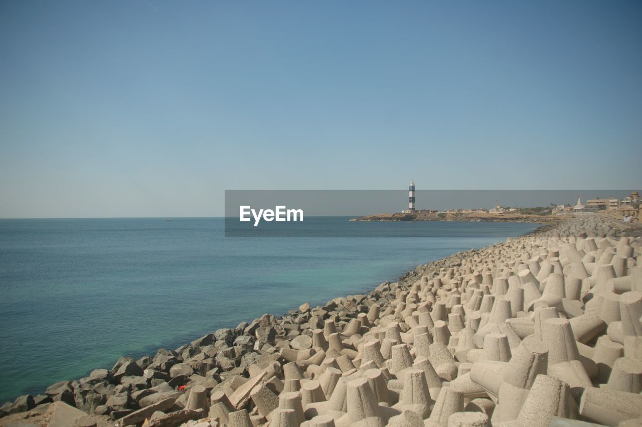 Scenic view of coastline against clear sky