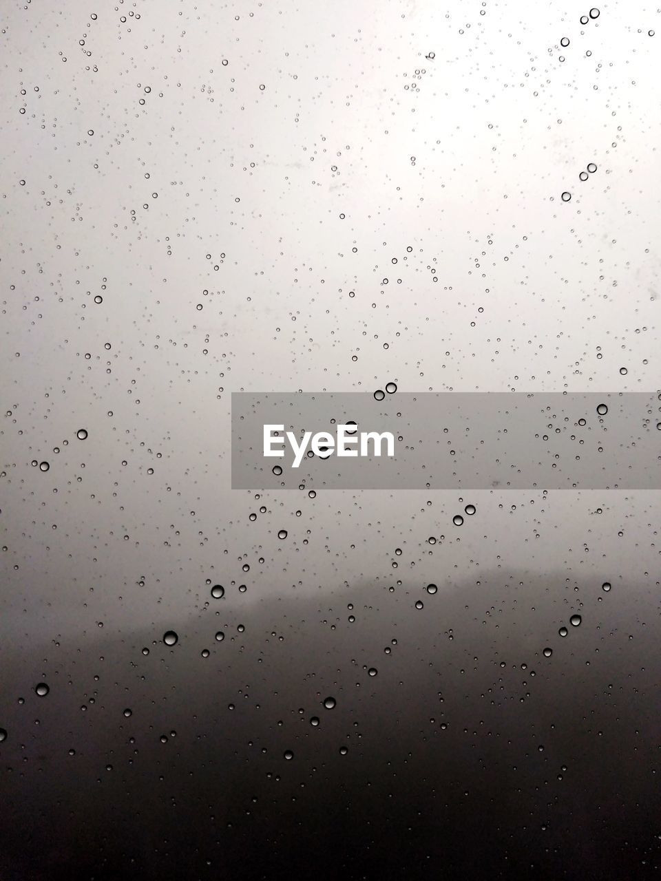 Full frame shot of raindrops on glass window