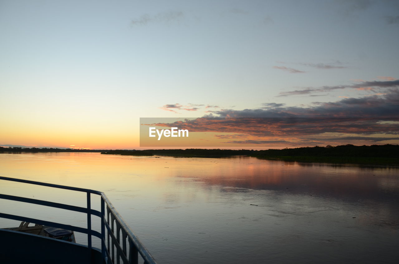 VIEW OF LAKE AGAINST SKY DURING SUNSET