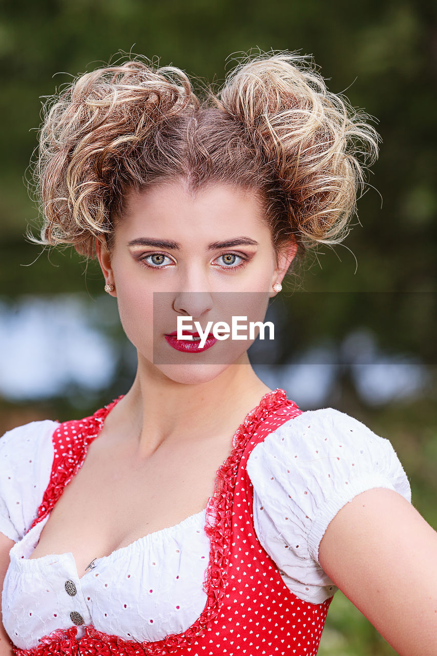 Close-up portrait of young woman wearing dirndl