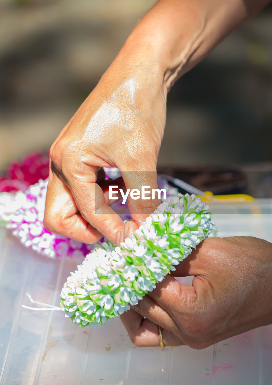 Close-up of woman making flower bouquet