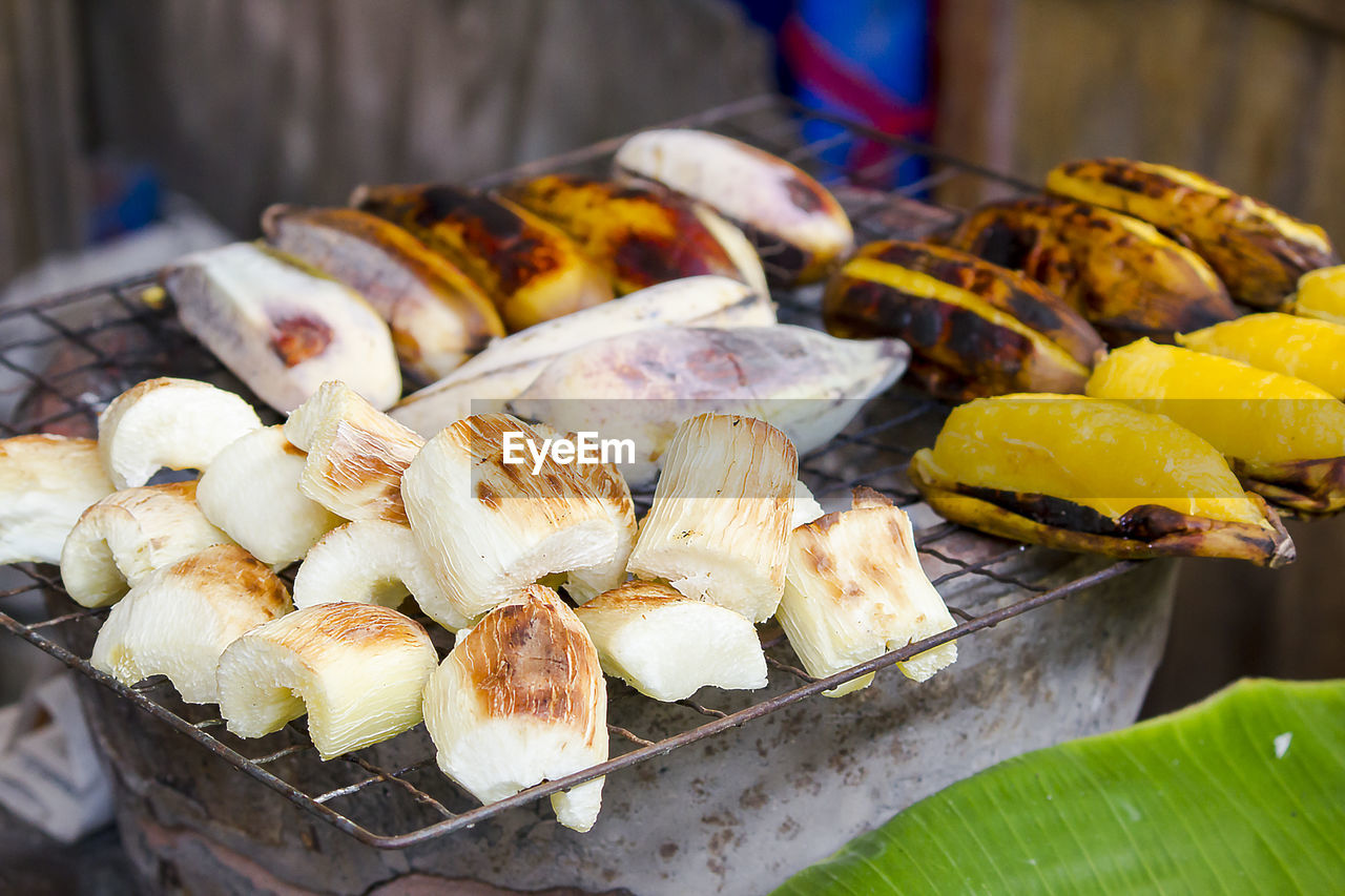 Cassava and roasted banana on the grille for sale in market
