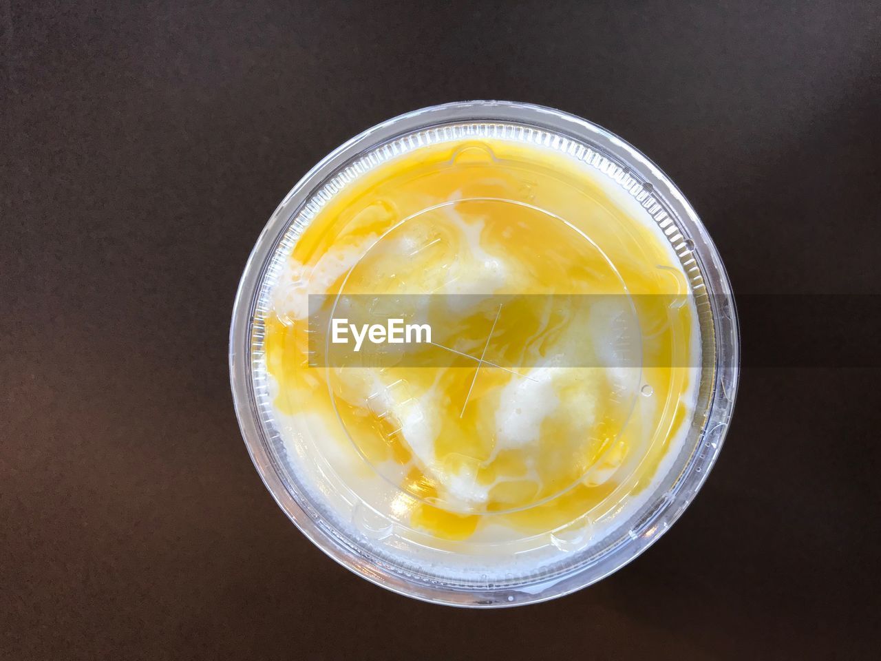 Directly above shot of orange yogurt drink on table