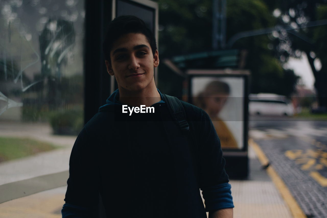 Portrait of young man in city