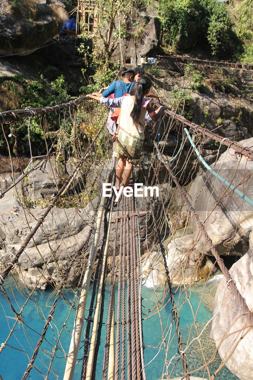 MAN WORKING ON BRIDGE