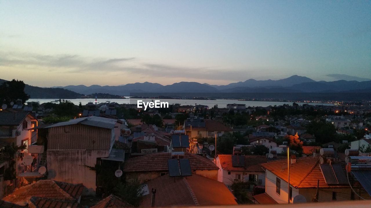 HIGH ANGLE VIEW OF TOWNSCAPE AND MOUNTAINS AGAINST SKY