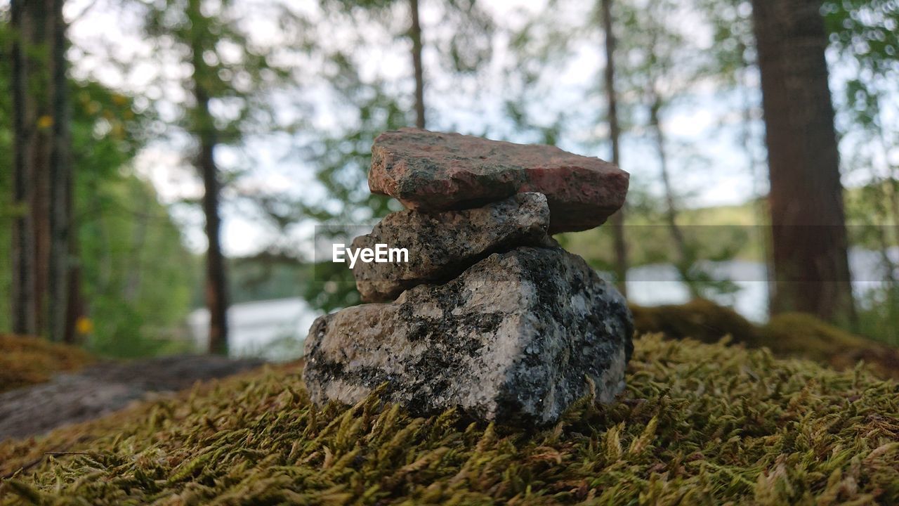 Close-up of stack of rocks on field