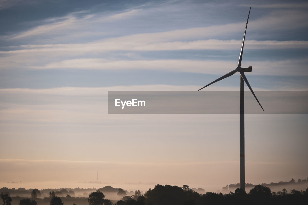 Low angle view of windmill against sky during sunset
