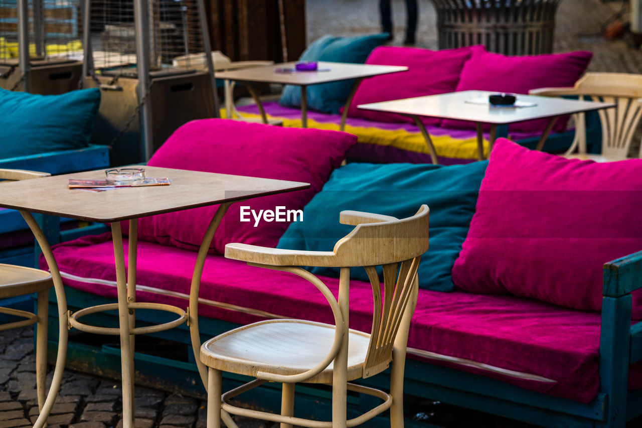 EMPTY CHAIRS AND TABLE AT RESTAURANT