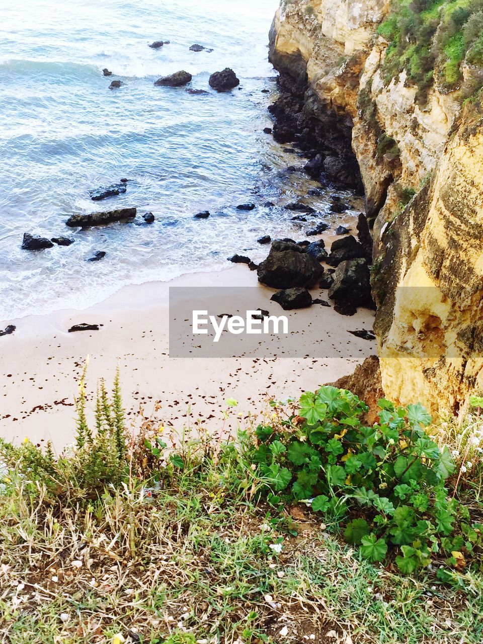 HIGH ANGLE VIEW OF ROCKS AT BEACH