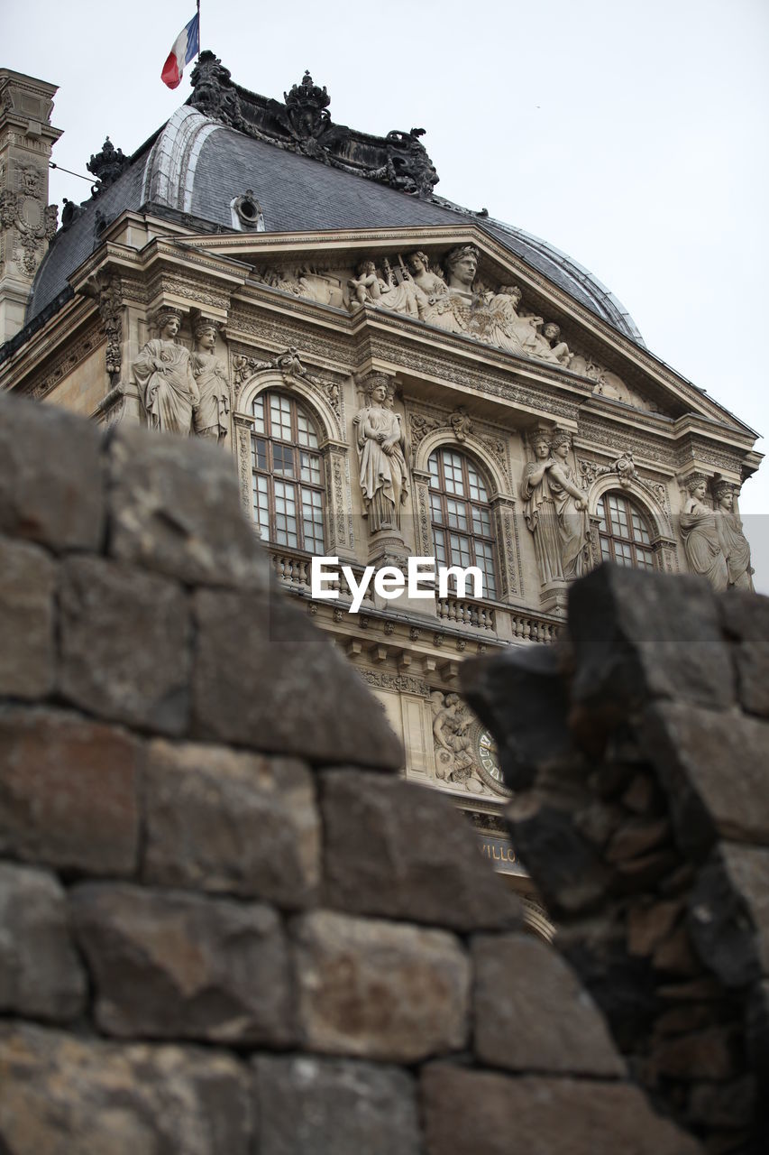 Low angle view of retaining wall against musee du louvre