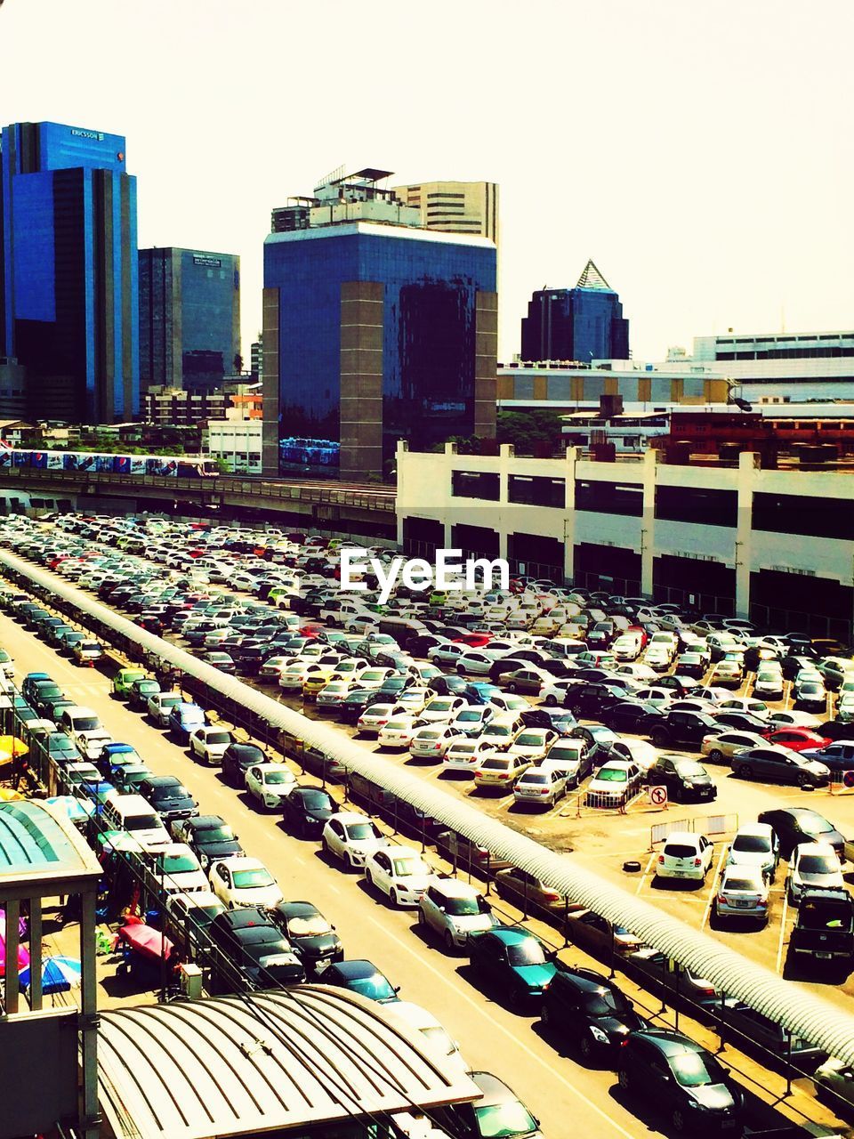 View of vehicles parked on road along buildings