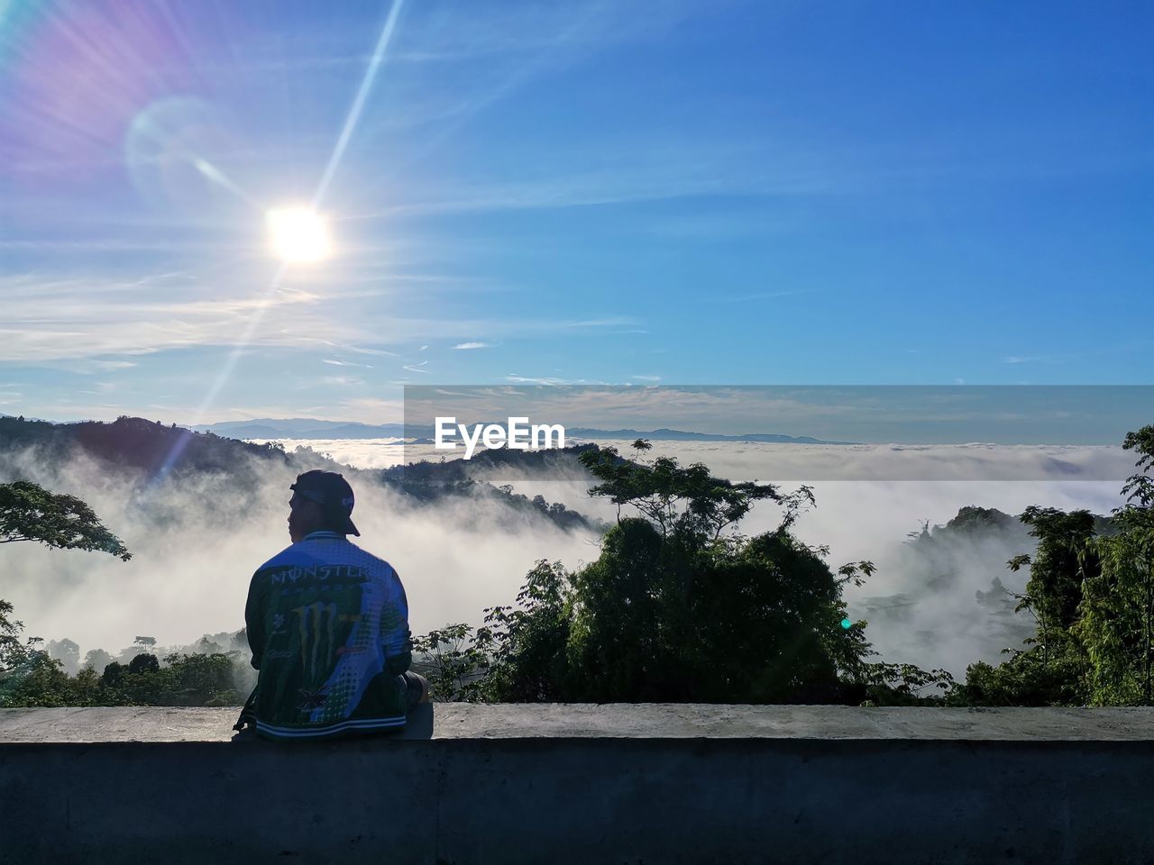 Rear view of man looking at waterfall