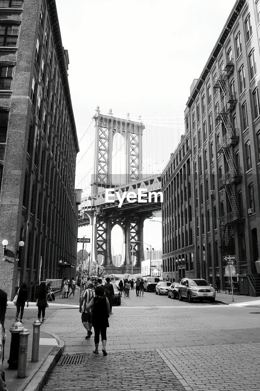 People walking on bridge in city