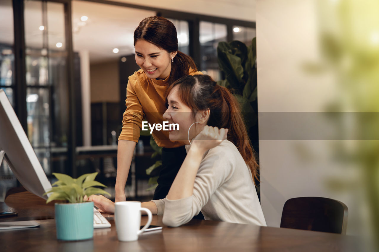 Smiling colleagues working in office