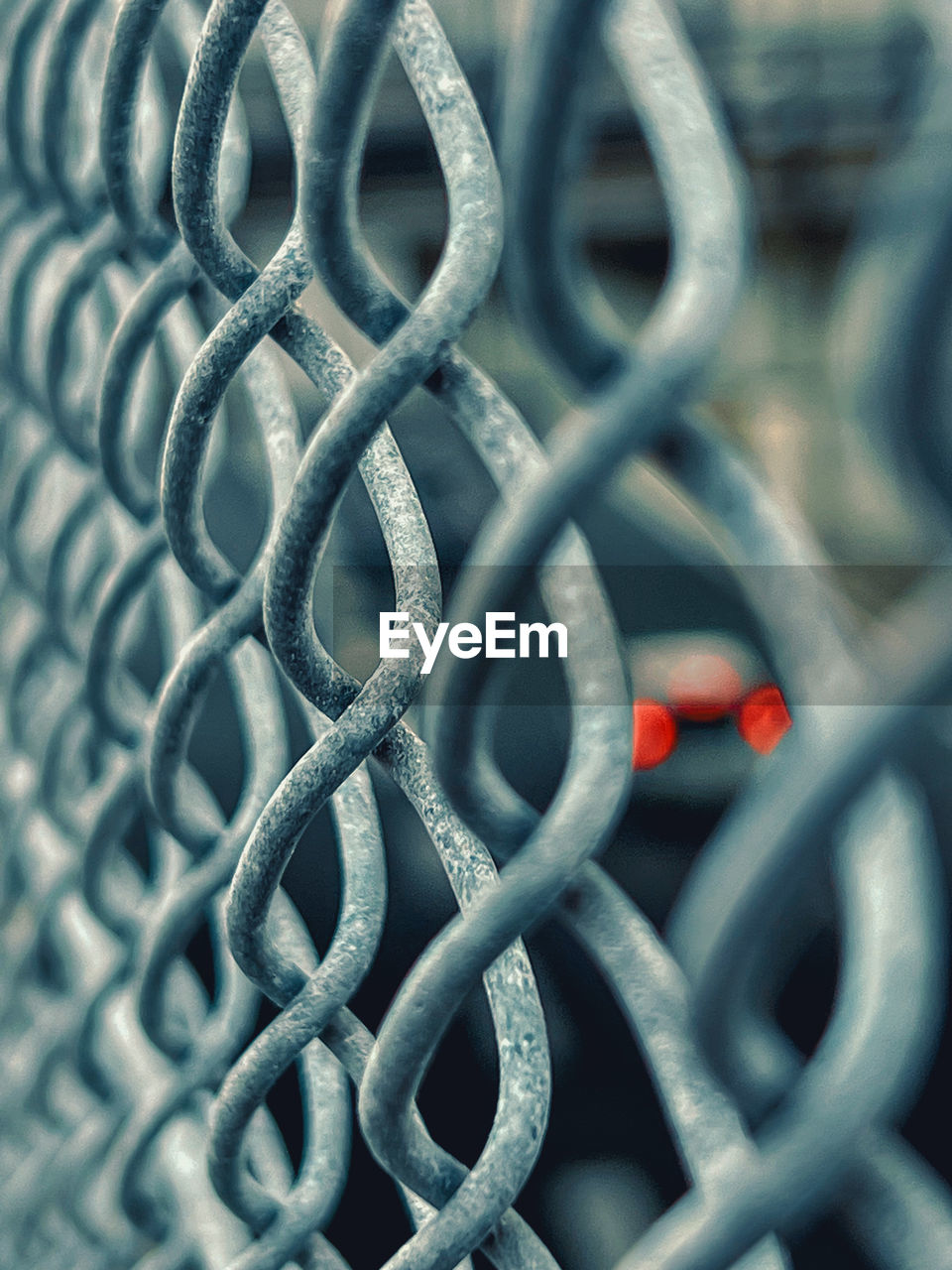 people walking on chainlink fence