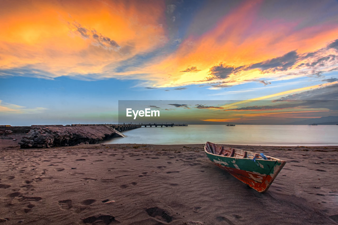 Scenic view of beach against sky during sunset