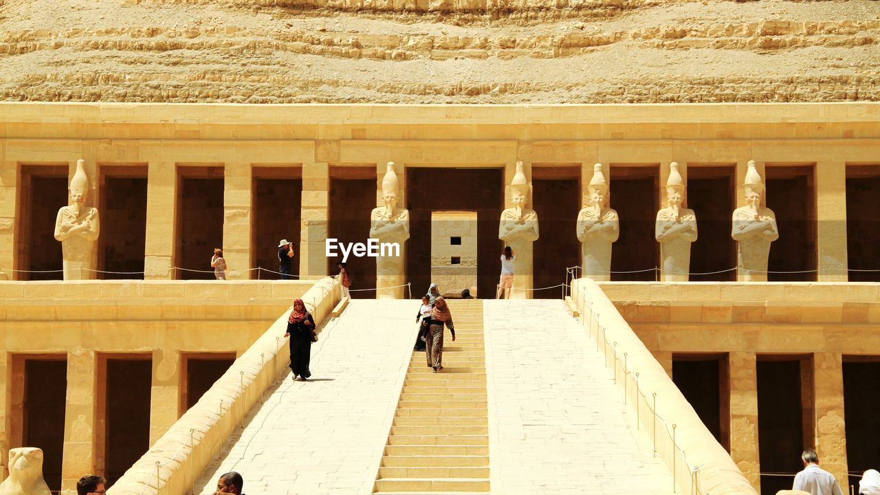 TOURISTS LOOKING AT VIEW OF HISTORICAL BUILDING