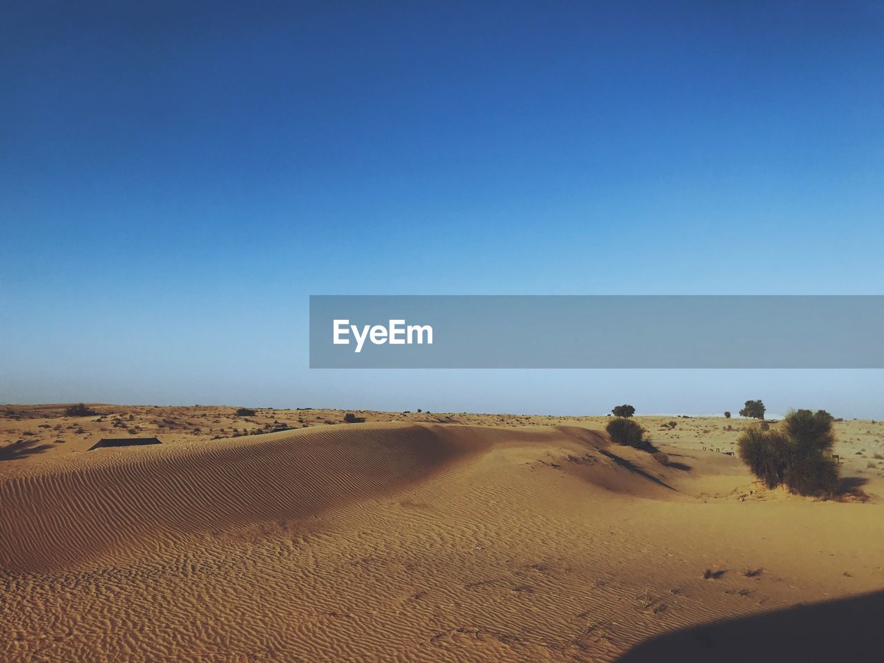 VIEW OF DESERT AGAINST CLEAR BLUE SKY