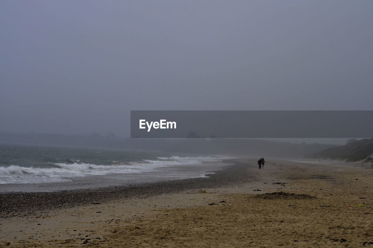 Scenic view of beach against clear sky