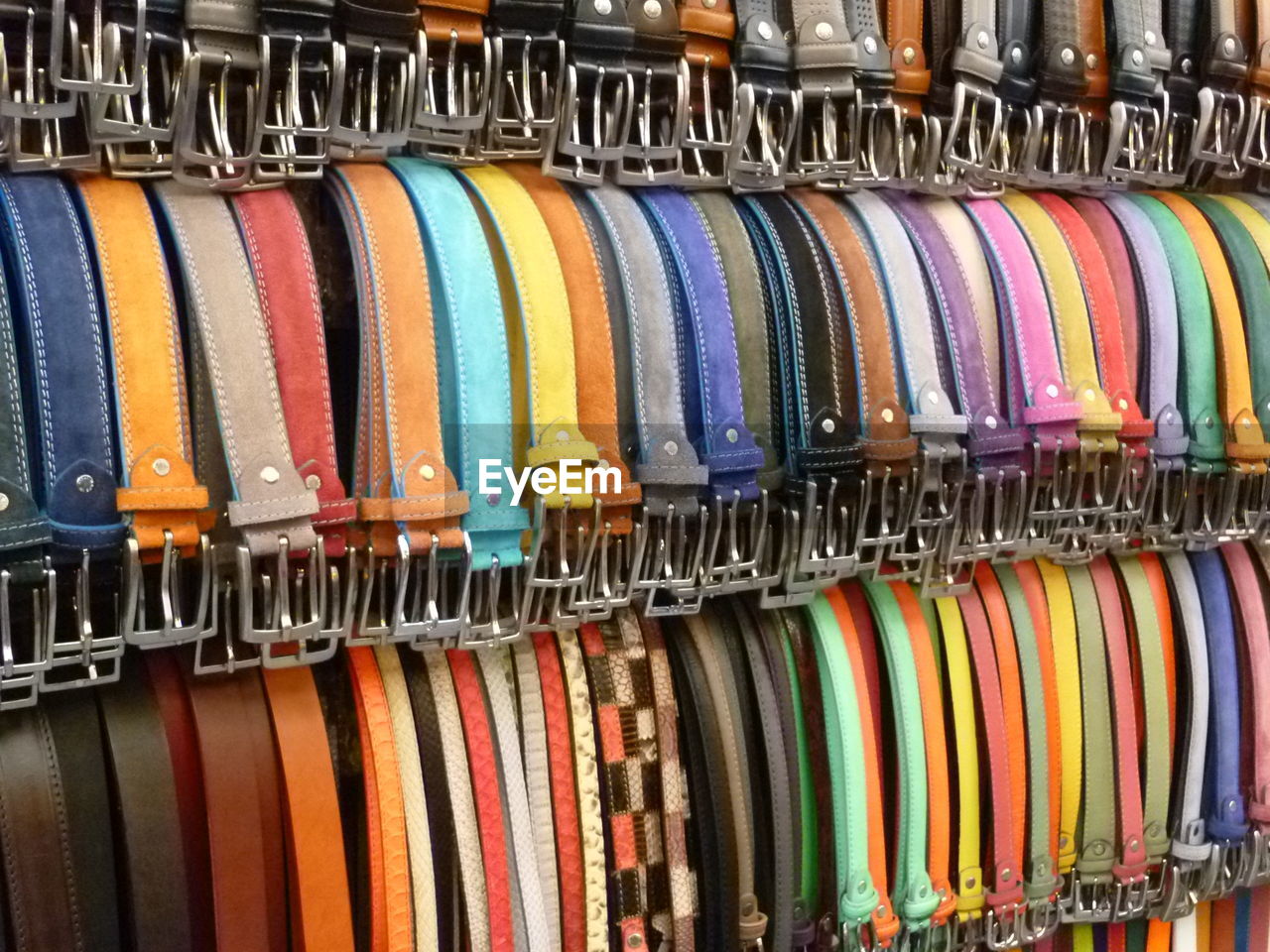 Colorful belts hanging in store