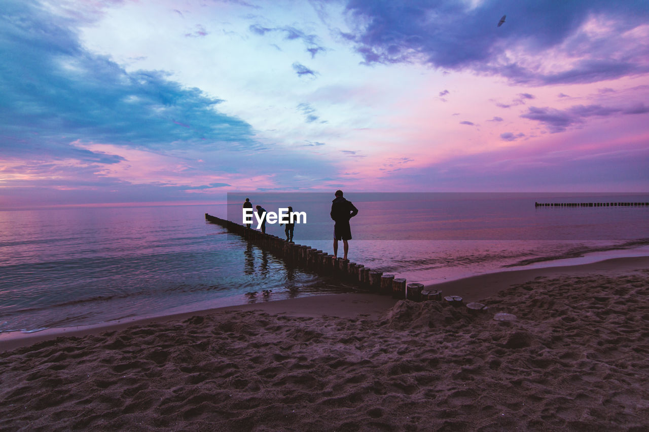 PEOPLE AT BEACH DURING SUNSET