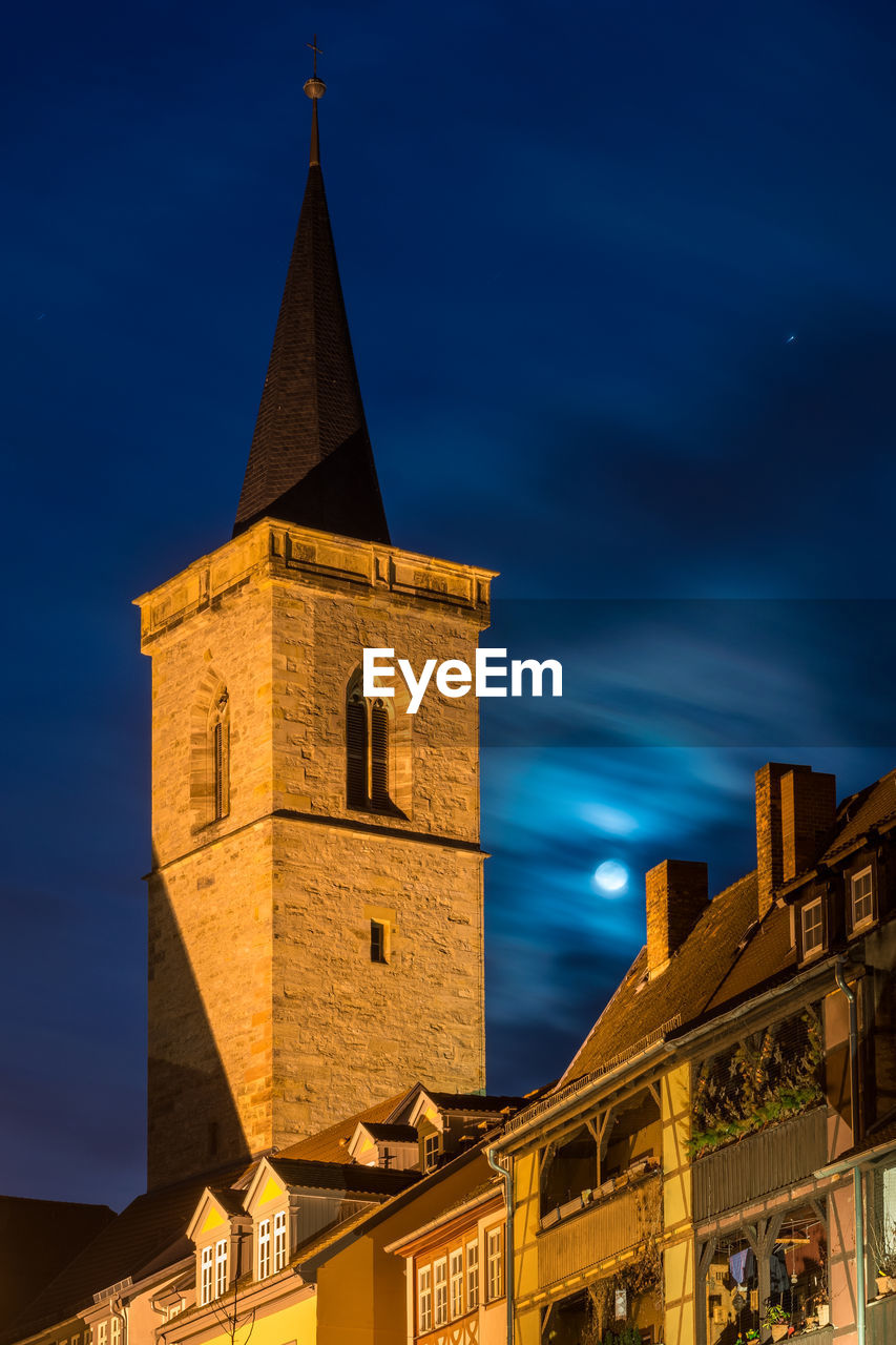 LOW ANGLE VIEW OF ILLUMINATED BUILDING AGAINST SKY