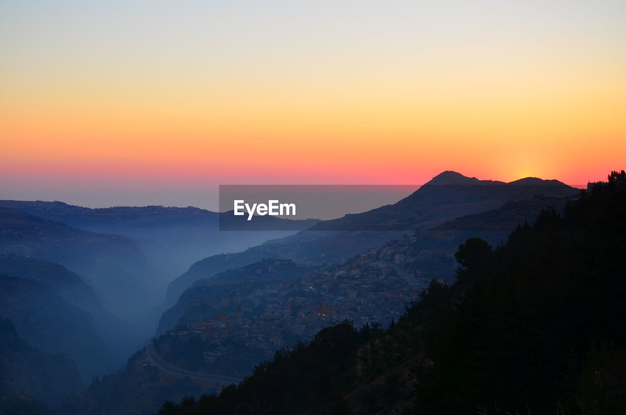 Tranquil view of mountain ranges against sky