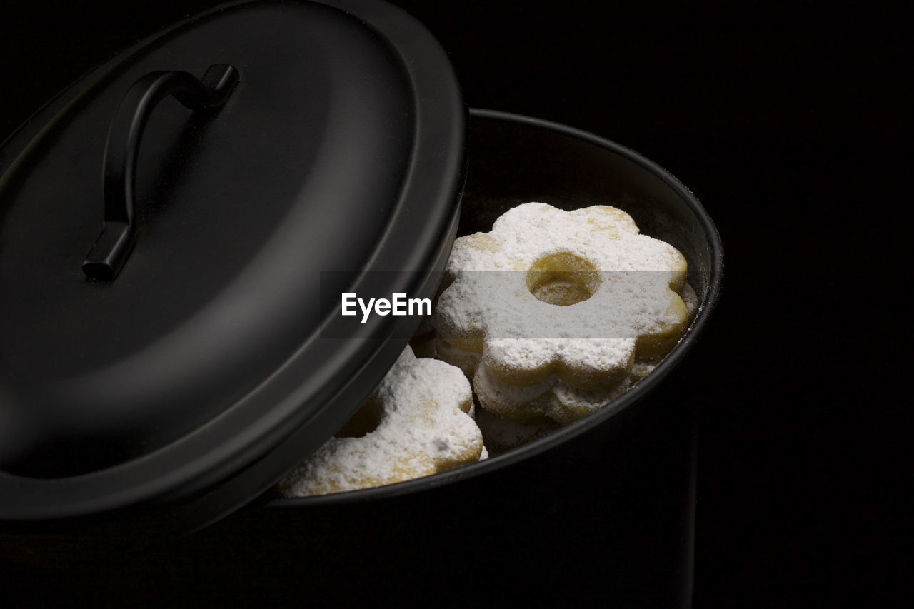 Canestrelli biscuits in black metal box on black background