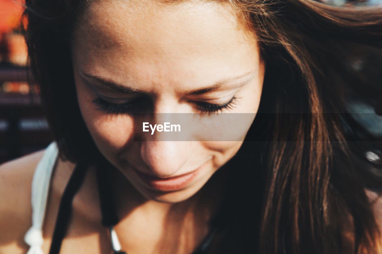 Close-up of young woman looking down