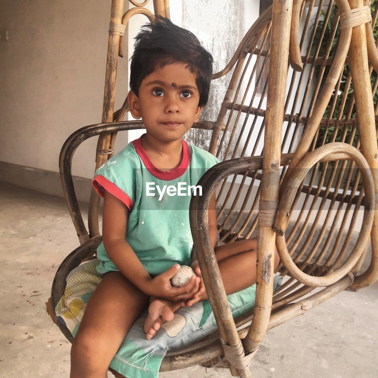 Portrait of cute girl sitting outdoors