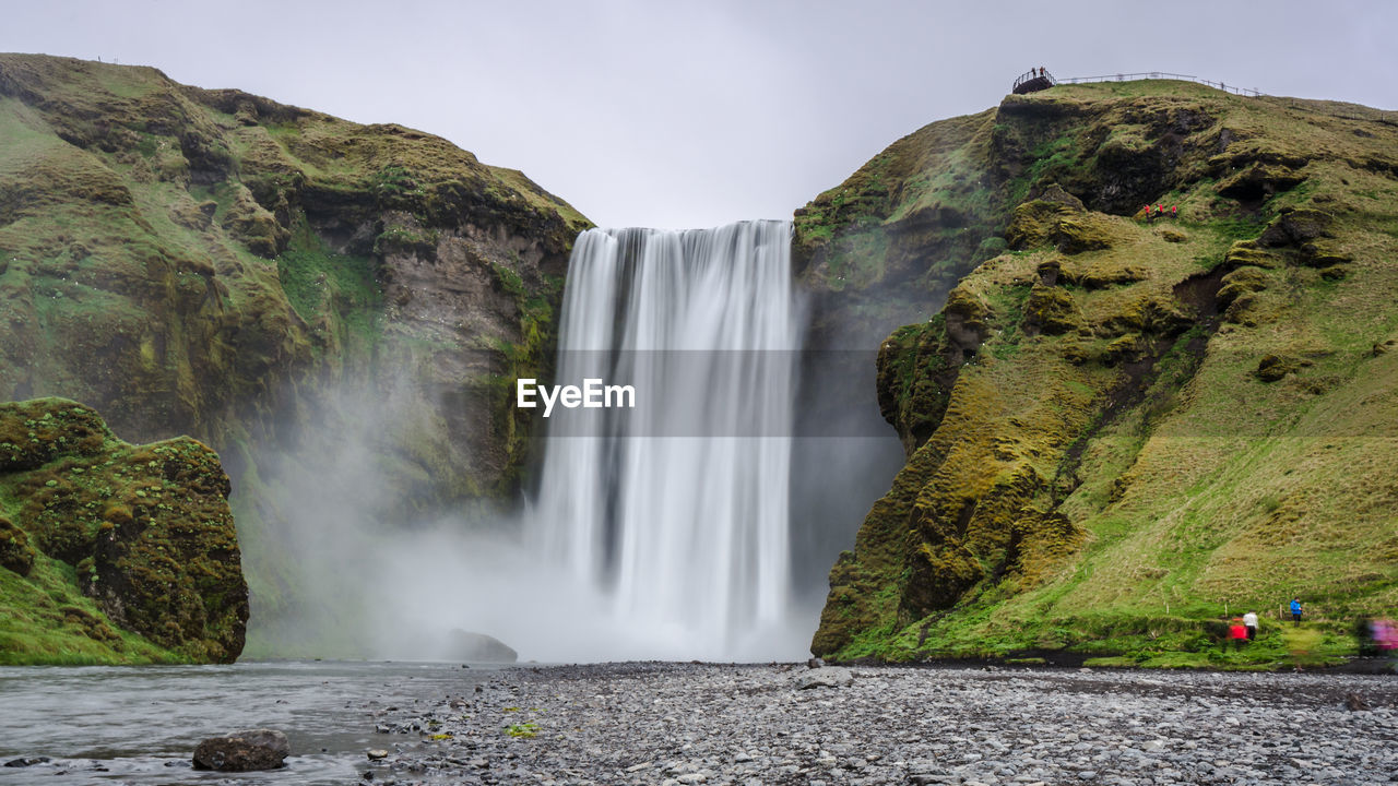 Scenic view of beautiful waterfall from cliff