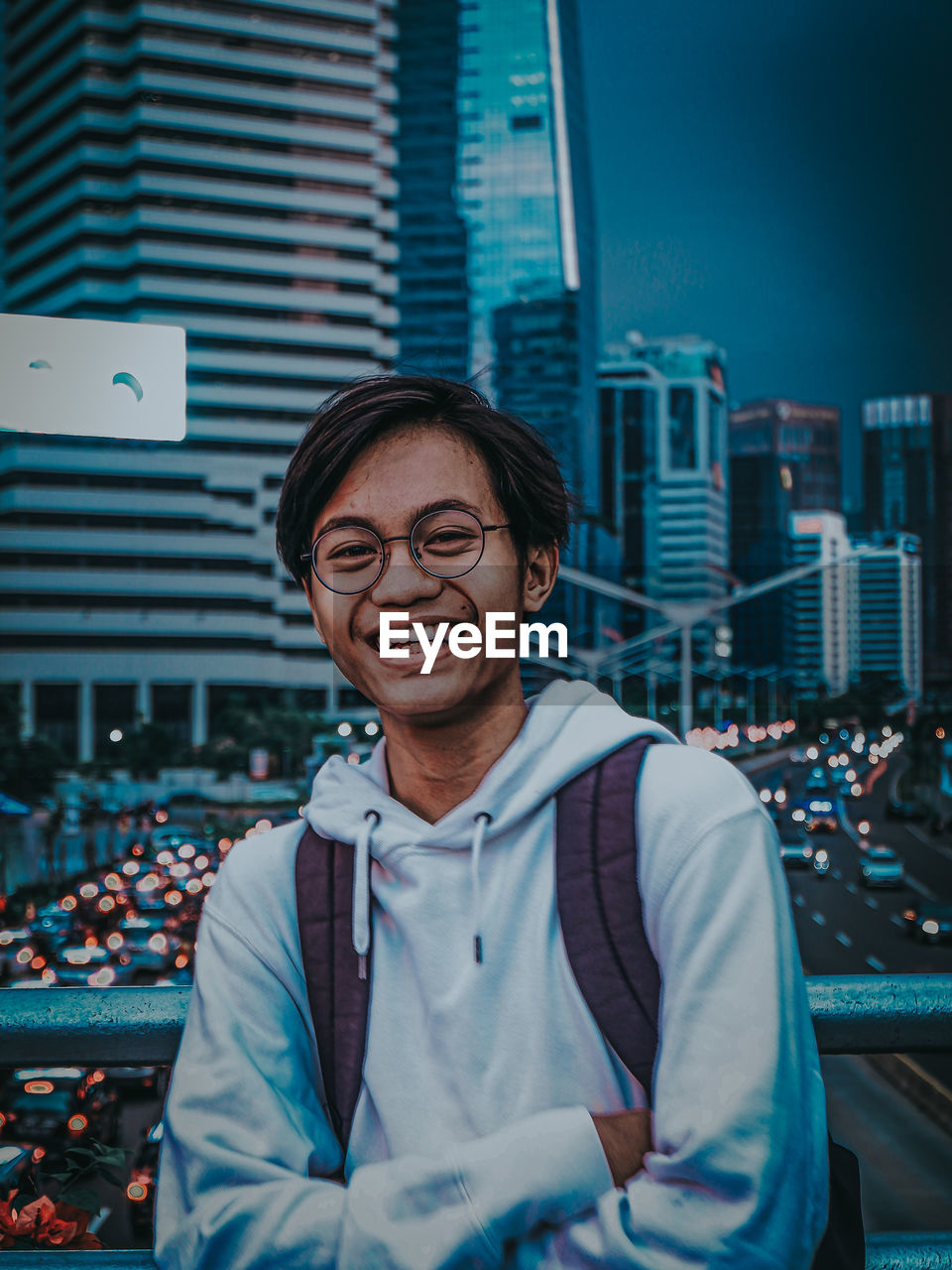 Portrait of smiling young man in city