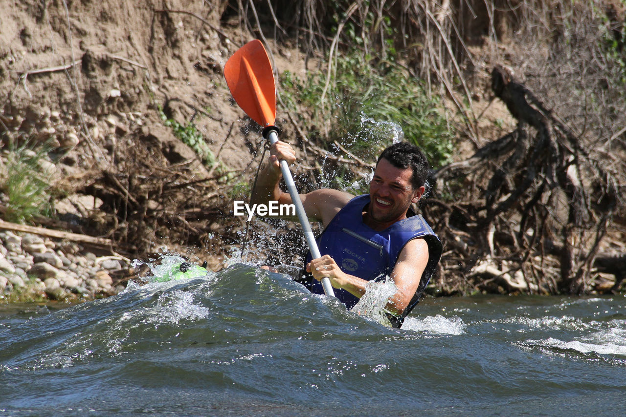 Man kayaking in river