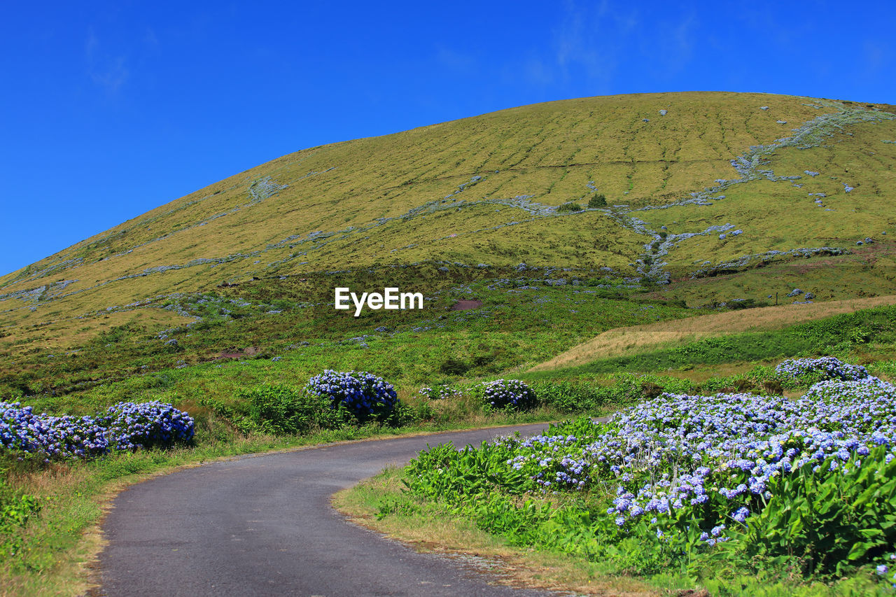 Scenic view of mountains against clear blue sky