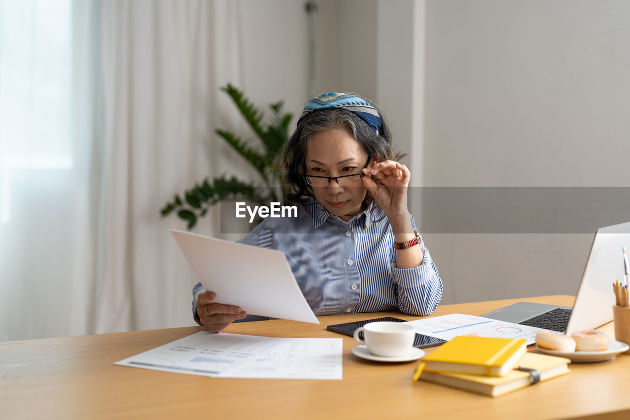 Businesswoman using laptop at office