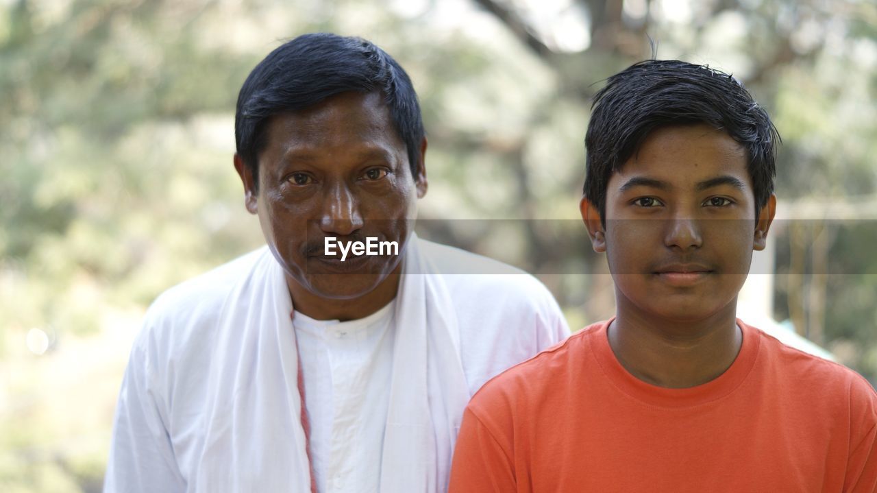 Portrait of men standing at park