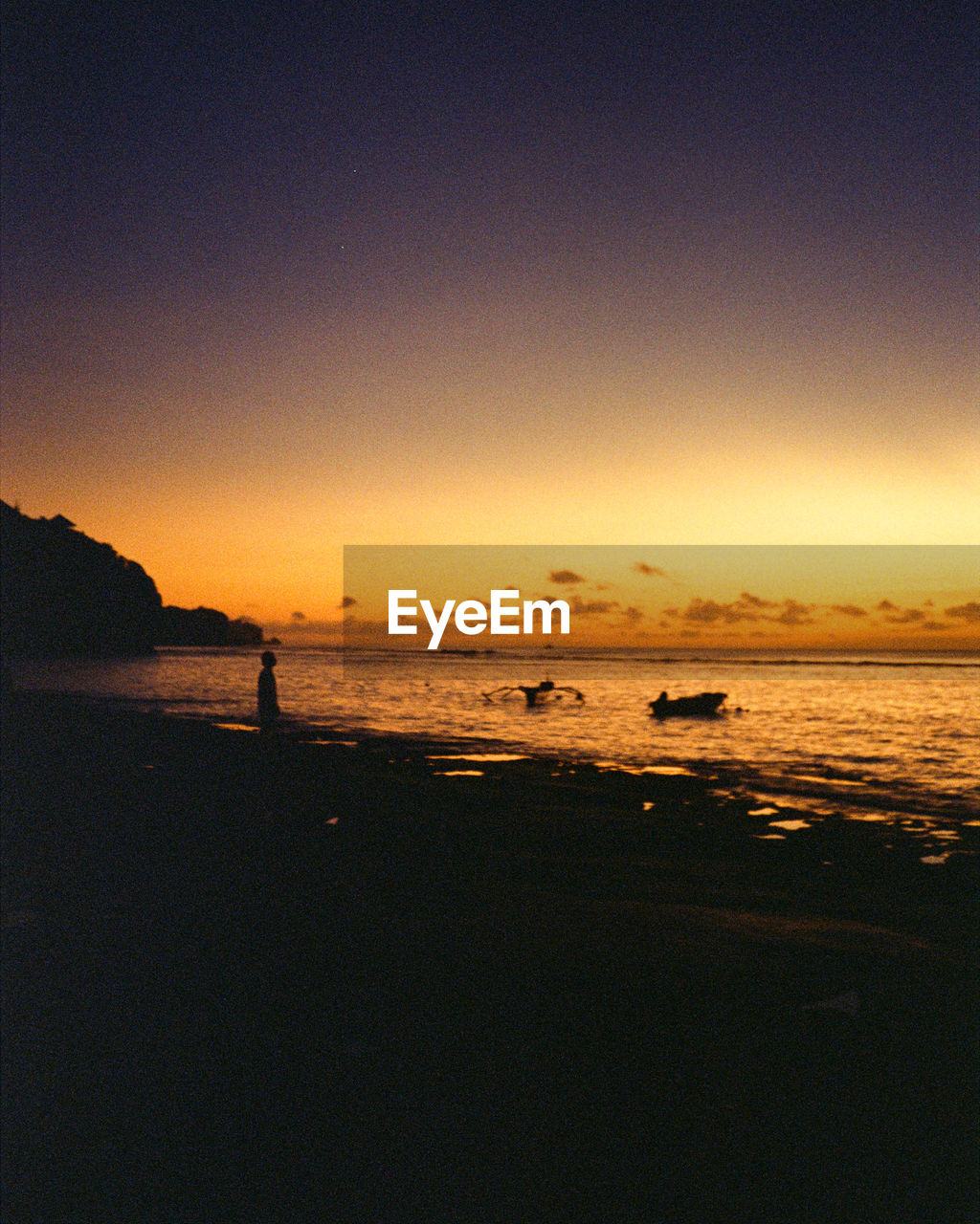 Scenic view of beach against sky during sunset