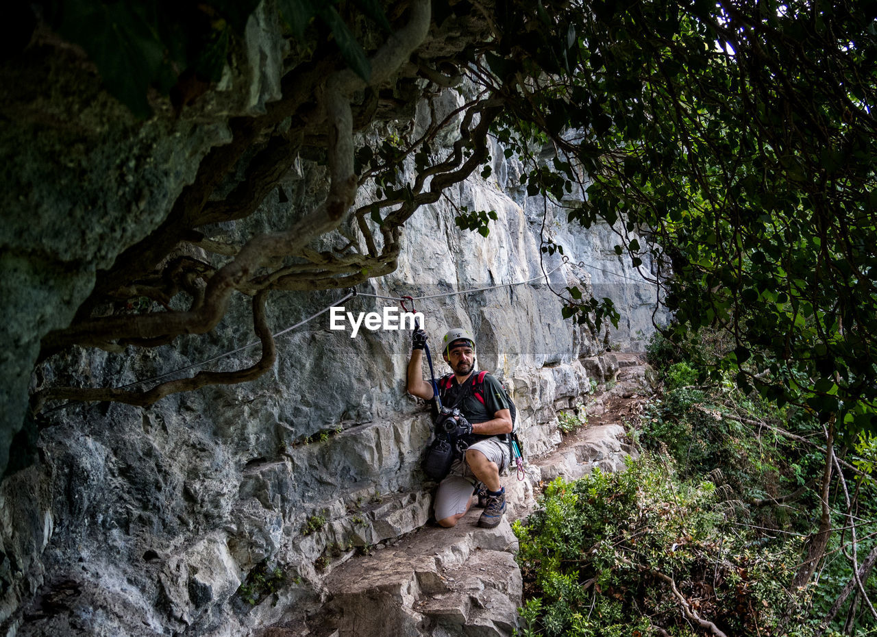 Mature man climbing on mountain