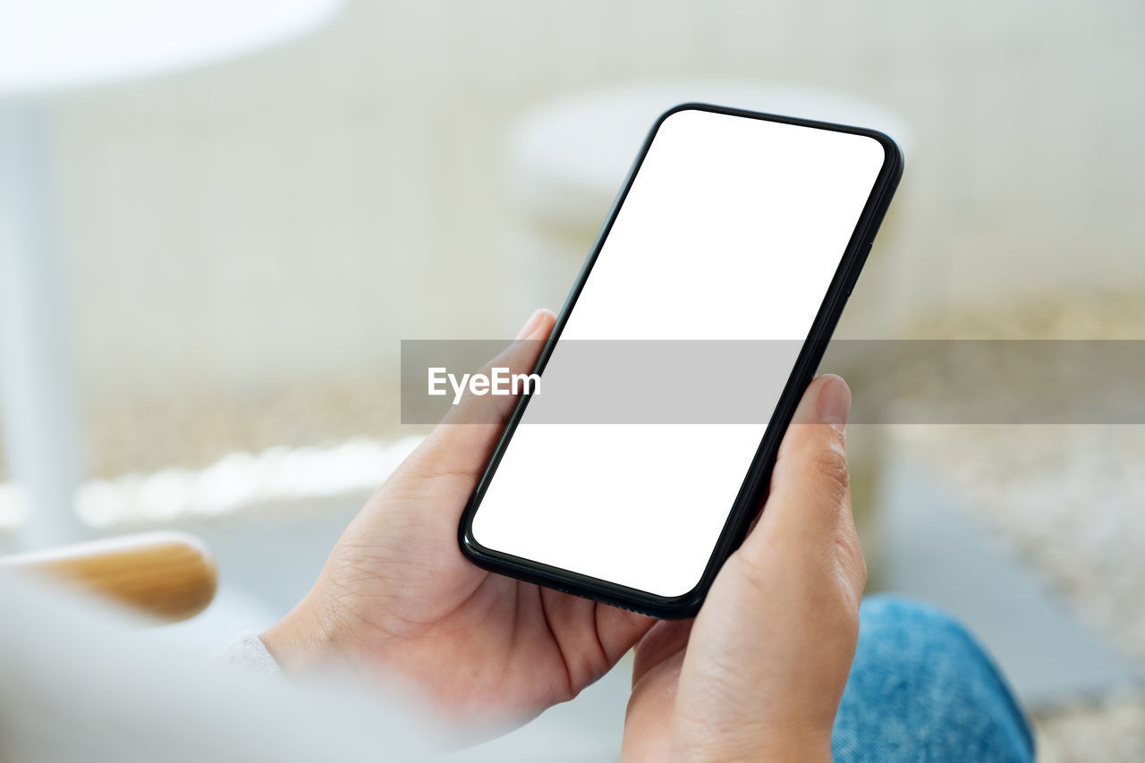 wireless technology, technology, communication, smartphone, portable information device, mobile phone, hand, one person, holding, adult, portability, telephone, screen, internet, digital tablet, touch screen, computer network, indoors, computer, close-up, using phone, selective focus, lifestyles, activity, copy space, business, furniture, selfie, focus on foreground, relaxation, device screen