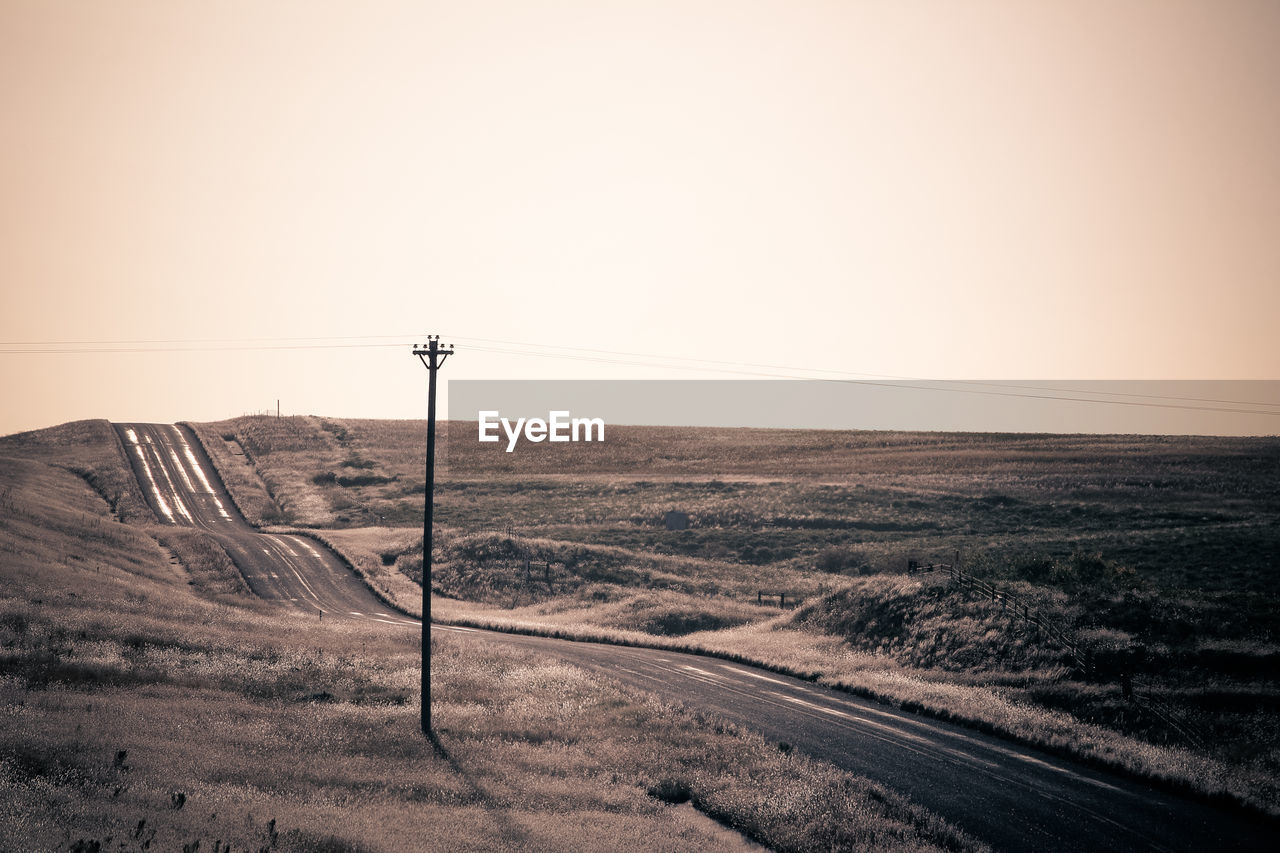 Scenic view of sand against clear sky