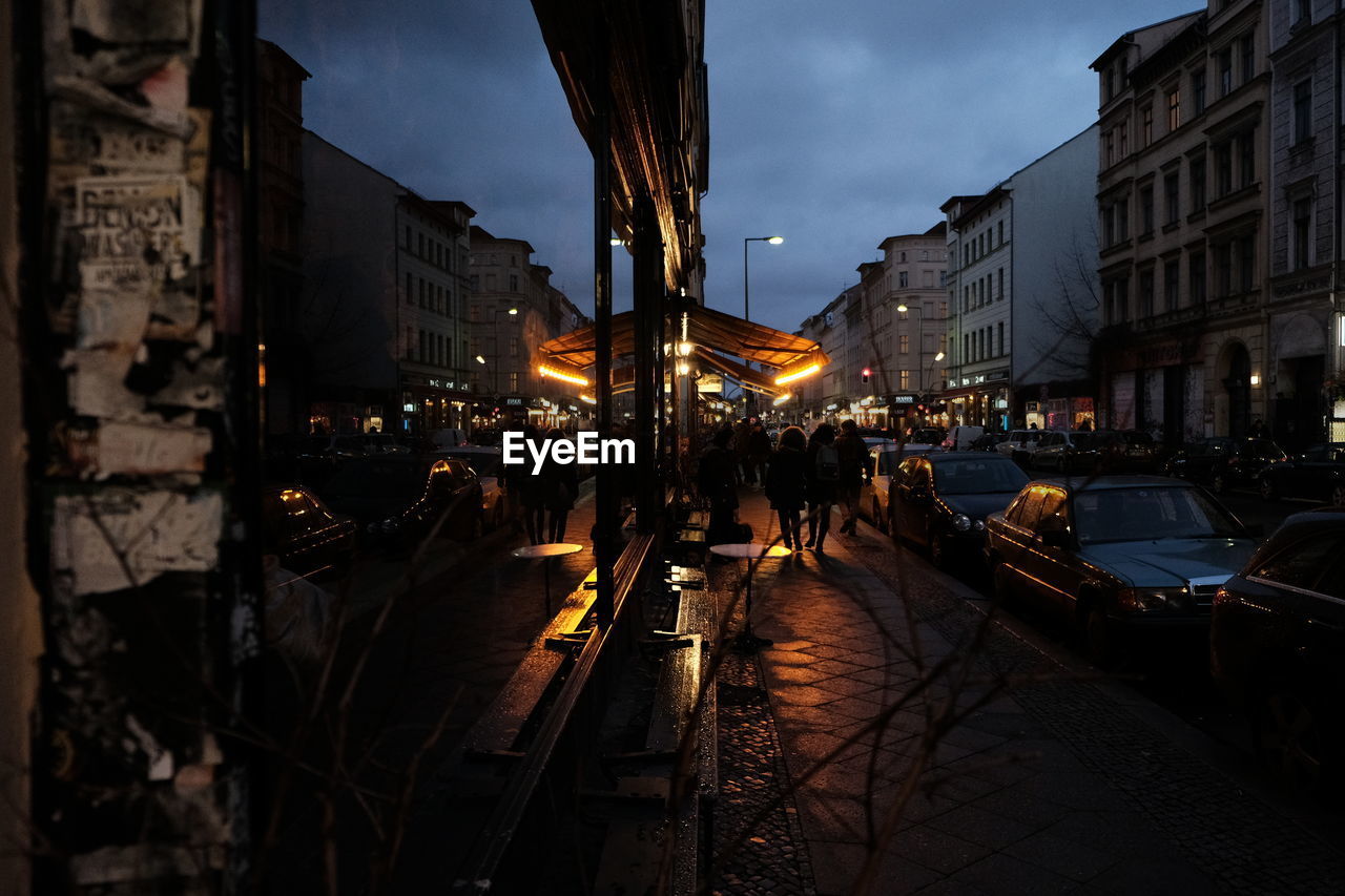 PEOPLE WALKING ON STREET AT NIGHT