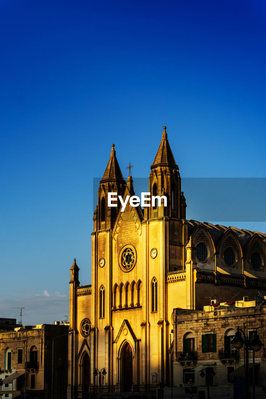 Low angle view of church against blue sky