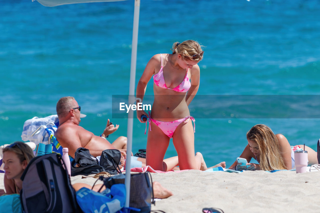 PEOPLE ENJOYING AT BEACH
