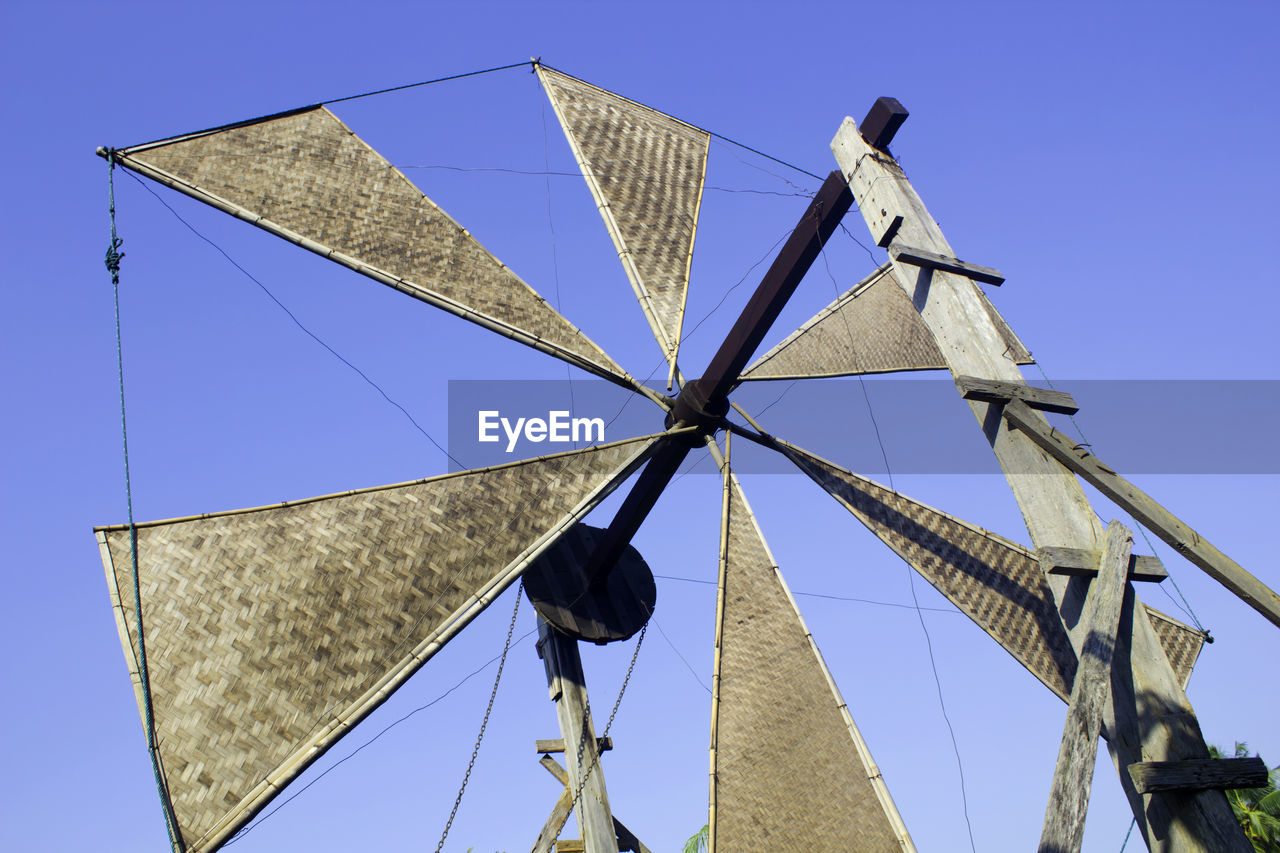 LOW ANGLE VIEW OF UMBRELLA AGAINST BLUE SKY