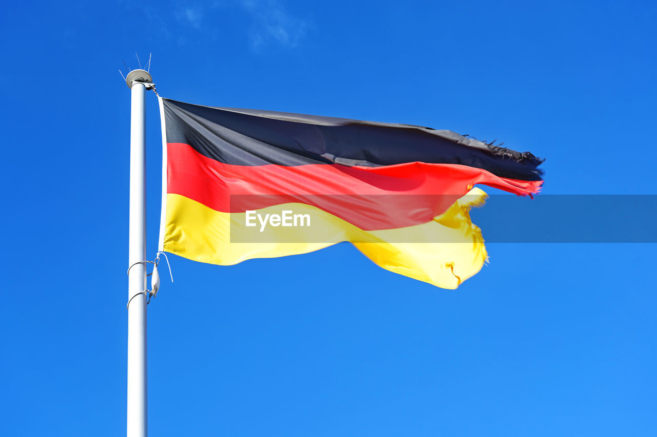 LOW ANGLE VIEW OF FLAGS FLAG AGAINST BLUE SKY