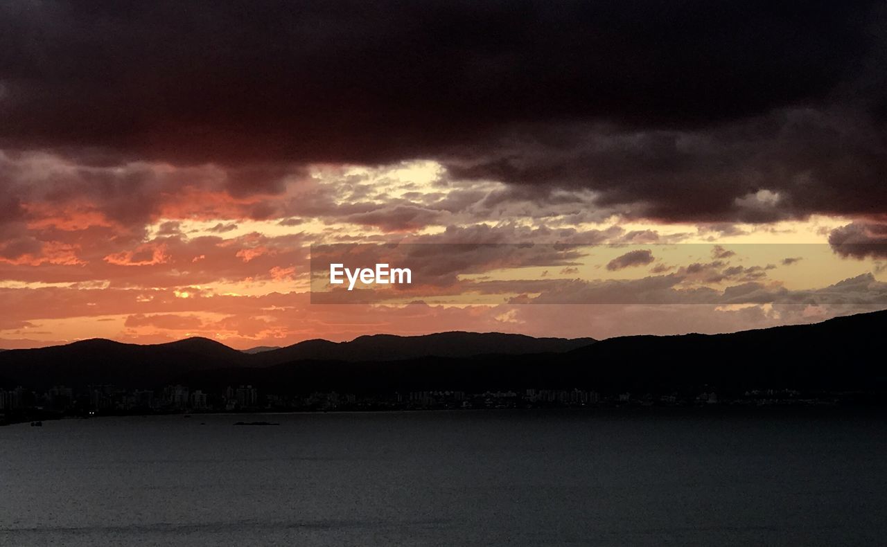 SCENIC VIEW OF DRAMATIC SKY DURING SUNSET