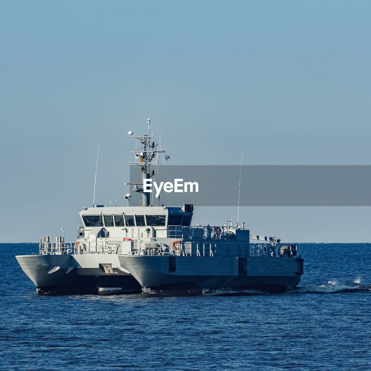 SHIPS ON SEA AGAINST CLEAR SKY