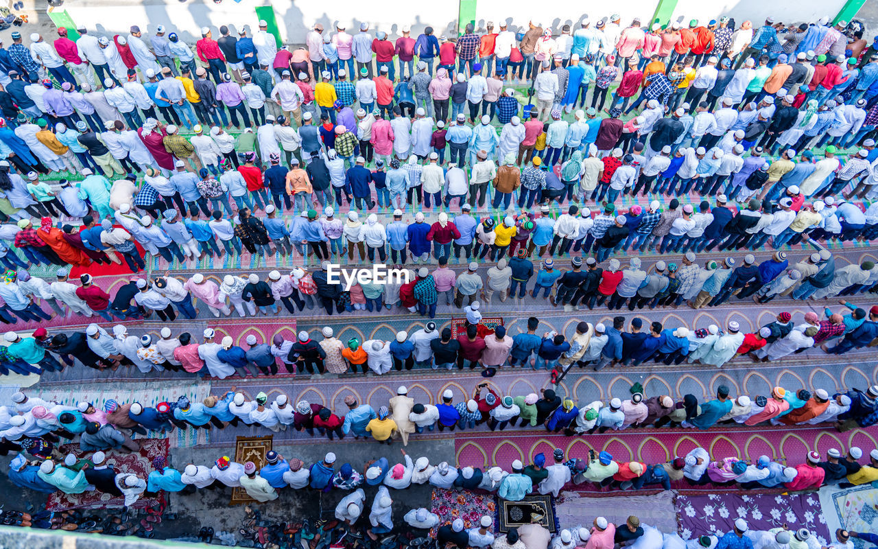 High angle view of crowd praying on road