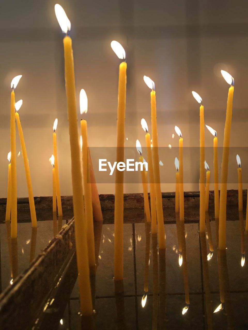Close-up of illuminated candles in church at night